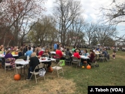 Visitors enjoy a vegan pot-luck picnic with the free-roaming turkeys at Poplar Spring Animal Sanctuary in Poolesville, Maryland.