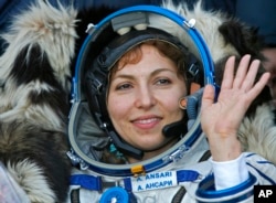 U.S. space tourist Anousheh Ansari waves shortly after landing in northern Kazakhstan."I just love that feeling of freedom that you get from being in space, and I certainly got addicted to it," she told AP after landing. Photo taken Sept. 29, 2006 (AP Photo)