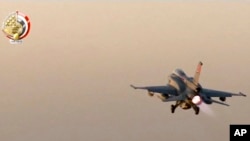 FILE - In this still image taken from video provided by the Egyptian military, an Egyptian fighter jet takes off from an undisclosed location in Egypt to strike militant hideouts in the Libyan city of Darna, May 26, 2017.