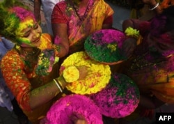 Indian students play with coloured powders to celebrate Holi festival in Kolkata on March 1, 2018.