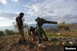 Turkish-backed Free Syrian Army fighters prepare a TOW anti-tank missile north of the city of Afrin, Syria Feb. 18, 2018.