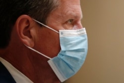 A couple sit on their car watch "Hours" at a drive-in movie event at a park, in Byblos town, north of Beirut, Lebanon, Friday, July 17, 2020. A group of Lebanese fresh university graduates have launched a drive-in cinema, bringing back the experience that