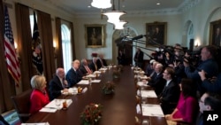 President Donald Trump, third from left, speaks during a bicameral meeting with lawmakers working on the tax cuts in the Cabinet Meeting Room of the White House in Washington, Wednesday, Dec. 13, 2017.