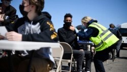 East Hartford High School junior Zander Robinson receives a vaccination from EMT Mary Kate Staunton of Clinton at a mass vaccination site at Pratt & Whitney Runway in East Hartford, Conn., Monday, April 26, 2021. (AP)