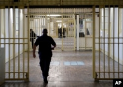 FILE - A guard walks in the corridor of Fresnes prison, south of Paris, France, Sept. 20, 2016.