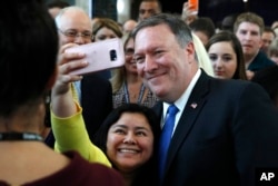 A State Department employee takes a selfie with new Secretary of State Mike Pompeo after he addressed employees on his arrival at the State Department in Washington, May 1, 2018.