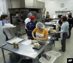 After going through its training program, Verred Joharie (center in yellow) is now employed at Sunflower Bakery and hopes to have a career in the baking industry.