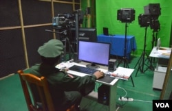 A KIA officer is seen in the studio of Laiza TV. (P. Vrieze for VOA)