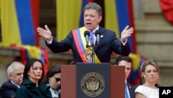 Wearing the presidential sash, newly sworn-in President Juan Manuel Santos, delivers his inaugural speech, in Bogota, Colombia, Aug. 7, 2014.