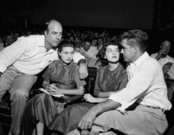 FILE - In this Sept. 23, 1955, file photo, J.W. Milam, left, his wife, second left, Roy Bryant, far right, and his wife, Carolyn Bryant, sit together in a courtroom in Sumner, Miss. Bryant and his half-brother Milam were charged with murder but acquitted.