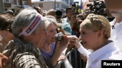Former Ukrainian prime minister and current presidential candidate Yulia Tymoshenko (R) meets supporters during her election campaign in the city of Konotop May 21, 2014. Campaigning for Ukraine's presidential election, Tymoshenko says she alone can save