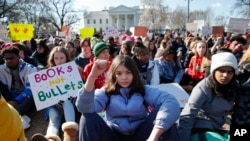 Students sit in silence as they rally in front of the White House in Washington, Wednesday, March 14, 2018. Students walked out of school to protest gun violence in the biggest demonstration yet of the student activism that has emerged in response to last month's massacre of 17 people at Florida's Marjory Stoneman Douglas High School. (AP Photo/Carolyn Kaster)