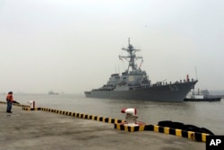 FILE - Chinese Navy personnel stand guard as guided missile destroyer USS Stethem arrives at the Shanghai International Passenger Quay for a scheduled port visit in Shanghai, China, Nov. 16, 2015.