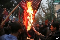 Hardline Iranian demonstrators burn representations of the U.S. flag during a gathering in front of the former U.S. Embassy in Tehran, Iran, May 9, 2018, reacting to President Donald Trump's decision to pull out of the nuclear deal.