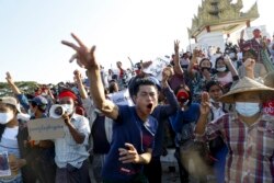 Demonstrators flash a three-fingered symbol of resistance against the military coup and shout slogans calling for the release of detained Myanmar leader Aung San Suu Kyi during a protest in Mandalay, Myanmar on Feb. 10, 2021.