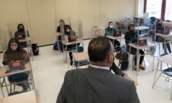 Secretary of Education Miguel Cardona talks to students at White Plains High School, Thursday, April 22, 2021, in White Plains, N.Y. (AP Photo/Mark Lennihan)
