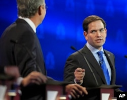 Marco Rubio, right, and Jeb Bush, argue a point during the CNBC Republican presidential debate at the University of Colorado, Wednesday, Oct. 28, 2015.