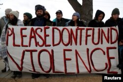Opponents of the Dakota Access oil pipeline rally outside the Bank of North Dakota in Bismarck, Jan. 31, 2017.