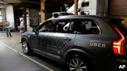 FILE - An Uber driverless car is displayed in a garage in San Francisco, Dec. 13, 2016. Uber announced Dec. 22, 2016, it is moving its self-driving cars to Arizona.