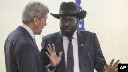South Sudan's President Salva Kiir, right, chats with U.S. Secretary of State John Kerry during a visit to Juba on Friday, May 2, 2014.