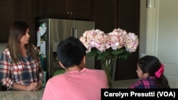 Felicia Luna, more relaxed after viewing her aneurysm through virtual reality, talks to her children on the day before her brain surgery.