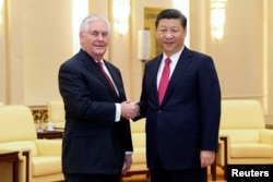 Chinese President Xi Jinping shakes hands with U.S. Secretary of State Rex Tillerson before their meeting at at the Great Hall of the People, March 19, 2017, in Beijing, China.