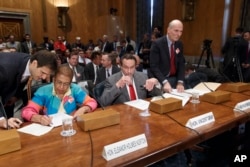FILE - From left, Delegate Eleanor Holmes Norton, the District of Columbia's nonvoting delegate in the U.S. House; then-D.C. Mayor Vincent C. Gray; and D.C. Council Chairman Philip H. Mendelson, prepare to testify before a Senate panel on a D.C. statehood bill, Sept. 15, 2014.