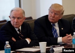 FILE - Donald Trump sits with U.S. Senator Jeff Sessions (R-AL) at Trump Tower in Manhattan, New York, Oct. 7, 2016.