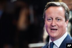 British Prime Minister David Cameron is seen leaving the EU Council building at the end of an EU summit in Brussels, early Sunday, Aug. 31, 2014.