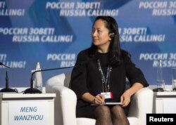 FILE - Meng Wanzhou, executive board director of the Chinese technology giant Huawei, attends a session of the VTB Capital Investment Forum "Russia Calling!" in Moscow, Russia Oct. 2, 2014.