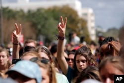 FILE - People participate in a gun control reform rally on the steps of the Capitol in Tallahassee, Florida, Feb. 21, 2018.