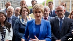Nicola Sturgeon, First Minister of Scotland and the leader of the Scottish National Party talks to the media as she meets new SNP Members of Parliament in Parliament Square, Westminster, London, June 12, 2017.