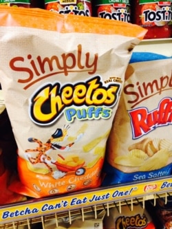 FILE - In this Jan. 24, 2014, file photo, Simply Cheetos are displayed in New York. Frito-Lay is opening a pop-up Cheetos-themed restaurant in New York City for three days beginning Tuesday, Aug. 15, 2017. (AP Photo/Candice Choi, File)