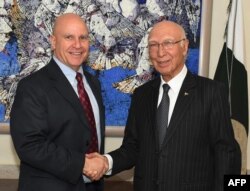 In this handout photograph released by the Press Information Department (PID) on April 17, 2017, Pakistan's National Security Advisor Sartaj Aziz (R) shakes hands with US National Security Adviser Lieutenant-General H.R. McMaster at the Foreign Ministry in Islamabad.