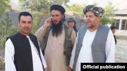 FILE - Mawlawi Habib Rahman, center, an Islamic State commander in northern Afghanistan, is seen in Jowzjan province.