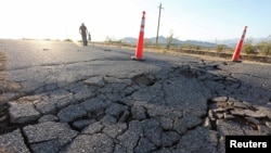 Cracks are shown in a highway caused by a powerful earthquake that struck Southern California near the city of Ridgecrest, California, U.S., July 4, 2019. REUTERS/David McNew