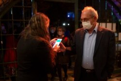 A man presents his "green passport," proof that he is vaccinated against the coronavirus, on opening night at the Khan Theater for a performance where all guests were required to show proof of vaccination or full recovery from the virus, in Jerusalem