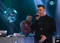 FILE - Naughty Boy and Sam Smith record 'La La La' for BBC 1's Christmas Day Special in London on Dec. 7, 2013.
