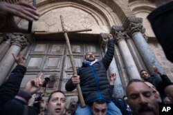 Demonstrators protest outside the closed doors of the Church of the Holy Sepulcher, traditionally believed by many Christians to be the site of the crucifixion and burial of Jesus Christ, in Jerusalem, Feb. 27, 2018.