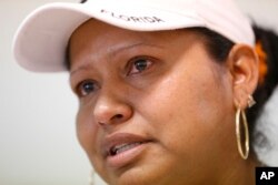 Tears well up in the eyes of Marina, 34, of Mexico, as she speaks during an interview with The Associated Press in Homestead, Fla., Feb. 13, 2017. A county with an immigrant leader where most people were born abroad has bucked the trend of the sanctuary city movement, creating fear among the undocumented.