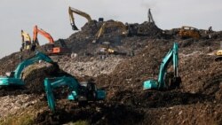 Heavy vehicles are seen at the Bantar Gebang landfill in Bekasi, West Java province, Indonesia, Aug. 12, 2021.