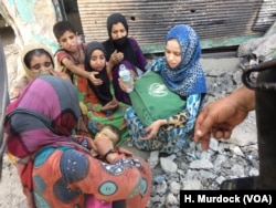 An Iraqi woman holds her baby who has just died only minutes they escaped Islamic State territory in Mosul, July 5, 2017.