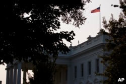 An American flag above the White House flies at full-staff less than 48 hours after the death of Sen. John McCain, Aug. 27, 2018, in Washington.
