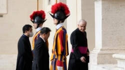 South Korea's President Moon Jae-in, center, is greeted by Head of the Papal Household, Mons. Leonardo Sapienza, right, as he arrives for a meeting with Pope Francis at the Vatican, Oct. 29, 2021.