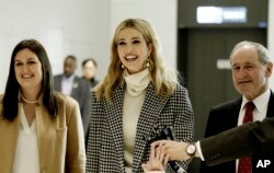 Flanked by White House Press Secretary Sarah Huckabee Sanders, left, Ivanka Trump, advisor to and daughter of U.S. President Donald Trump, speaks as she arrives at the Incheon International Airport in Incheon, South Korea, Feb. 23, 2018.