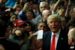 Republican presidential candidate Donald Trump meets with attendees during a campaign stop Feb. 2, 2016, in Milford, N.H.