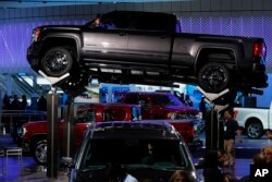 FILE - In this Tuesday, Jan. 12, 2016, file photo, a GMC Sierra 2500 Denali HD is displayed at the North American International Auto Show in Detroit. Four-door crew cab versions are built in Silao, Mexico.