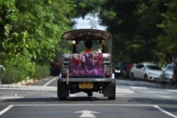 Tuk-tuk driver Samran Thammasa rides his vehicle decorated with a banner of K-pop star Jessica Jung, in Bangkok, Thailand May 12, 2021. (REUTERS/Chalinee Thirasupa)