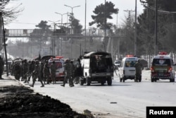 Army vehicles and ambulances gather outside the Bethel Memorial Methodist Church after an attack by gunmen, in Quetta, Pakistan, Dec. 17, 2017.