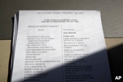 FILE - A lawsuit that was filed by the Democratic National Committee is photographed on April 20, 2018, in Washington. The national Democratic Party sued President Donald Trump's campaign, his son, his son-in-law, the Russian Federation, and WikiLeaks, accusing them of an intricate conspiracy to undercut Democrats in the 2016 election by stealing tens of thousands of emails and documents.